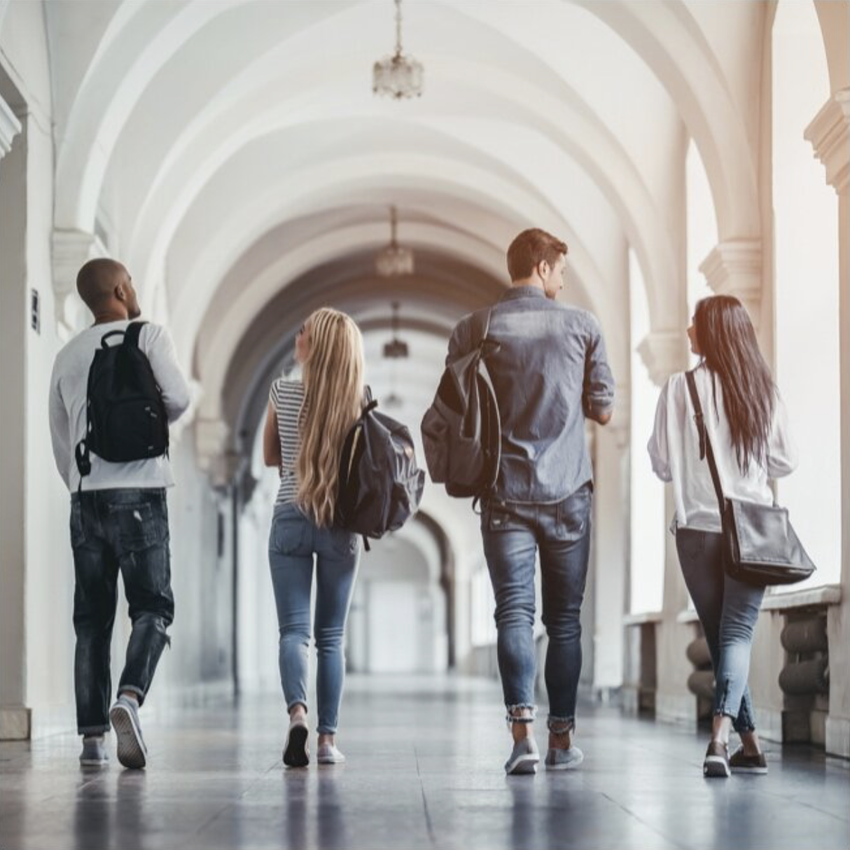 College students walk down a university hall.
